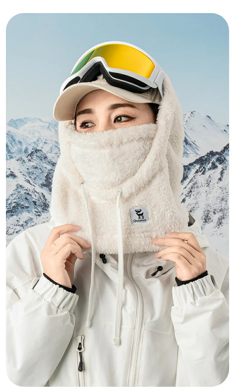 A girl wearing a white hood in the snow