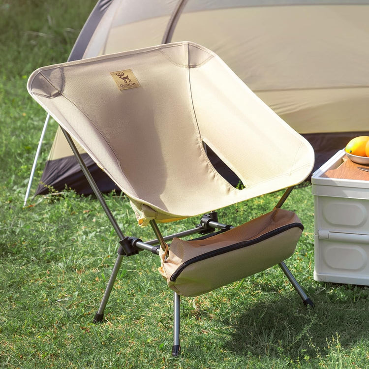 A folding chair outdoors on the grass