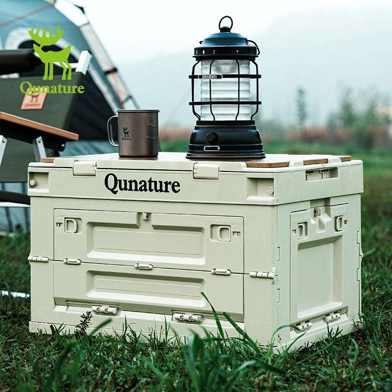 Qunature cooler box with a lantern and mug on top, outdoors.