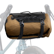 Brown quilted bike bag with black straps on a bicycle frame against a white background