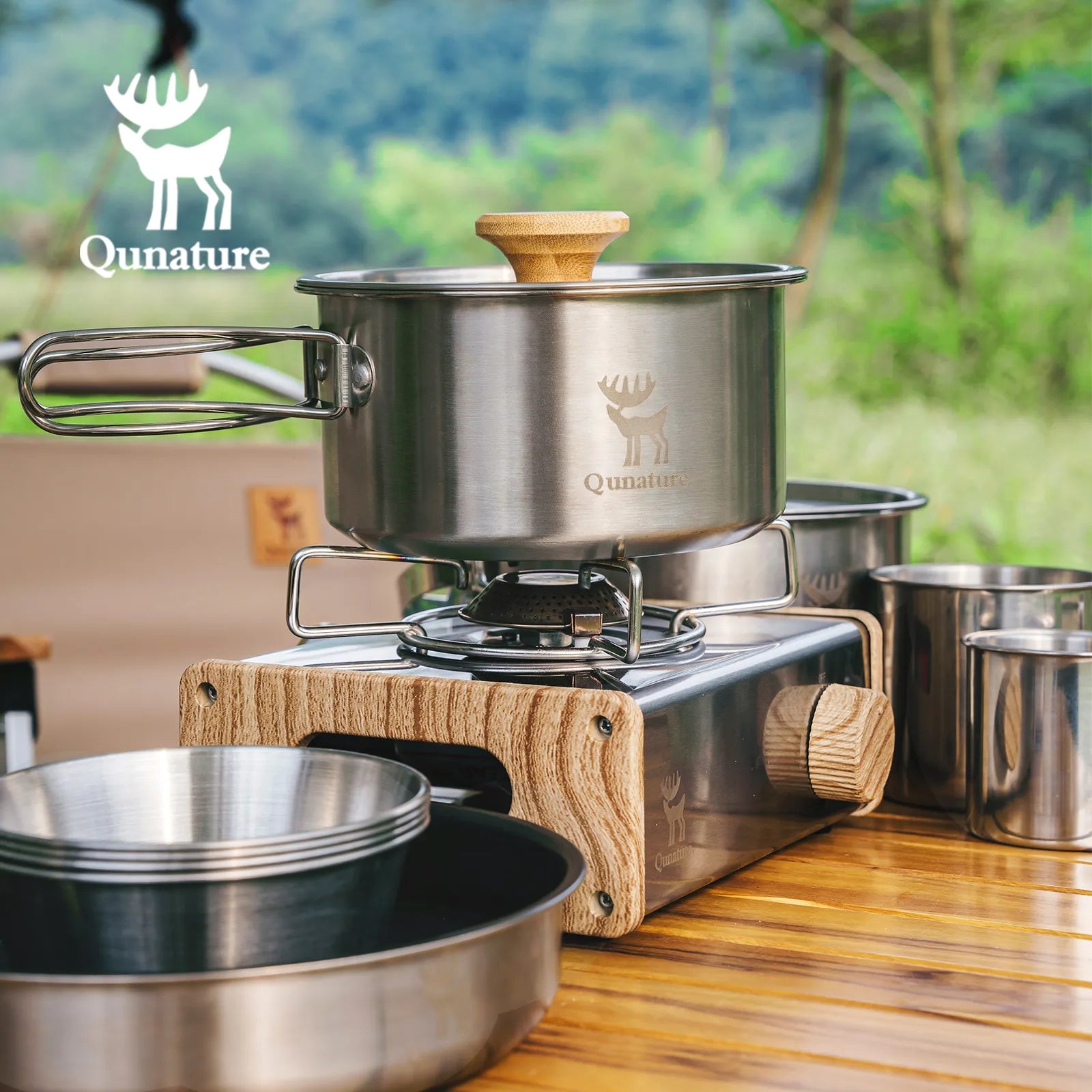 Cooking set with pots and a stove on a wooden surface, featuring the Qunature brand.