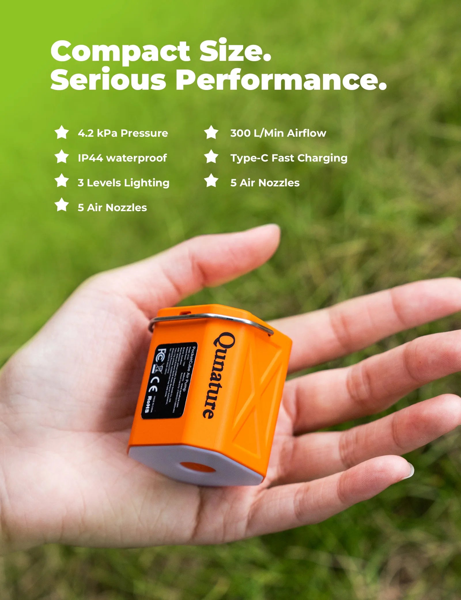 Orange device held in a hand with grass background and feature text overlay