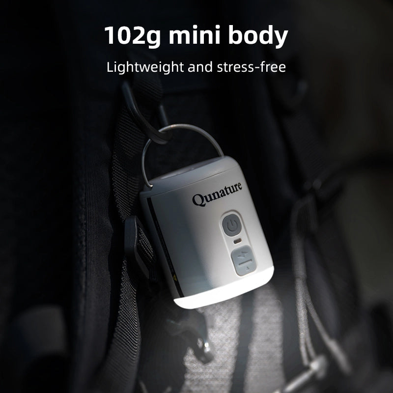 Qunature device with text highlighting weight and features, placed on a dark surface.