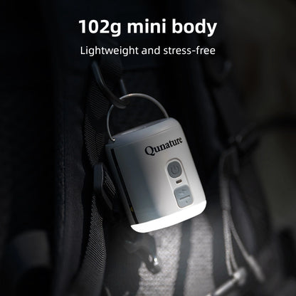 Qunature device with text highlighting weight and features, placed on a dark surface.