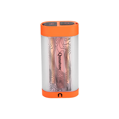 A cylindrical portable power bank with a clear body showing a pink and black topographic line pattern, finished with bright orange top and bottom caps. The brand name 'Qumaurus' is printed vertically on the center.