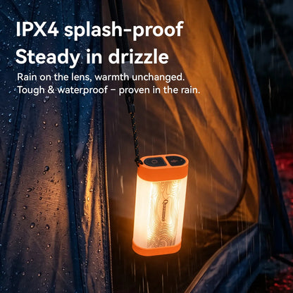 An orange and black camping lantern with a warm white light hangs inside a rain-covered tent. White text at the top reads 'IPX4 splash-proof Steady in drizzle' with additional rainproof claim copy below.