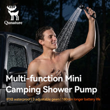Person using a camping shower pump with Qunature branding, set against a dark outdoor background.
