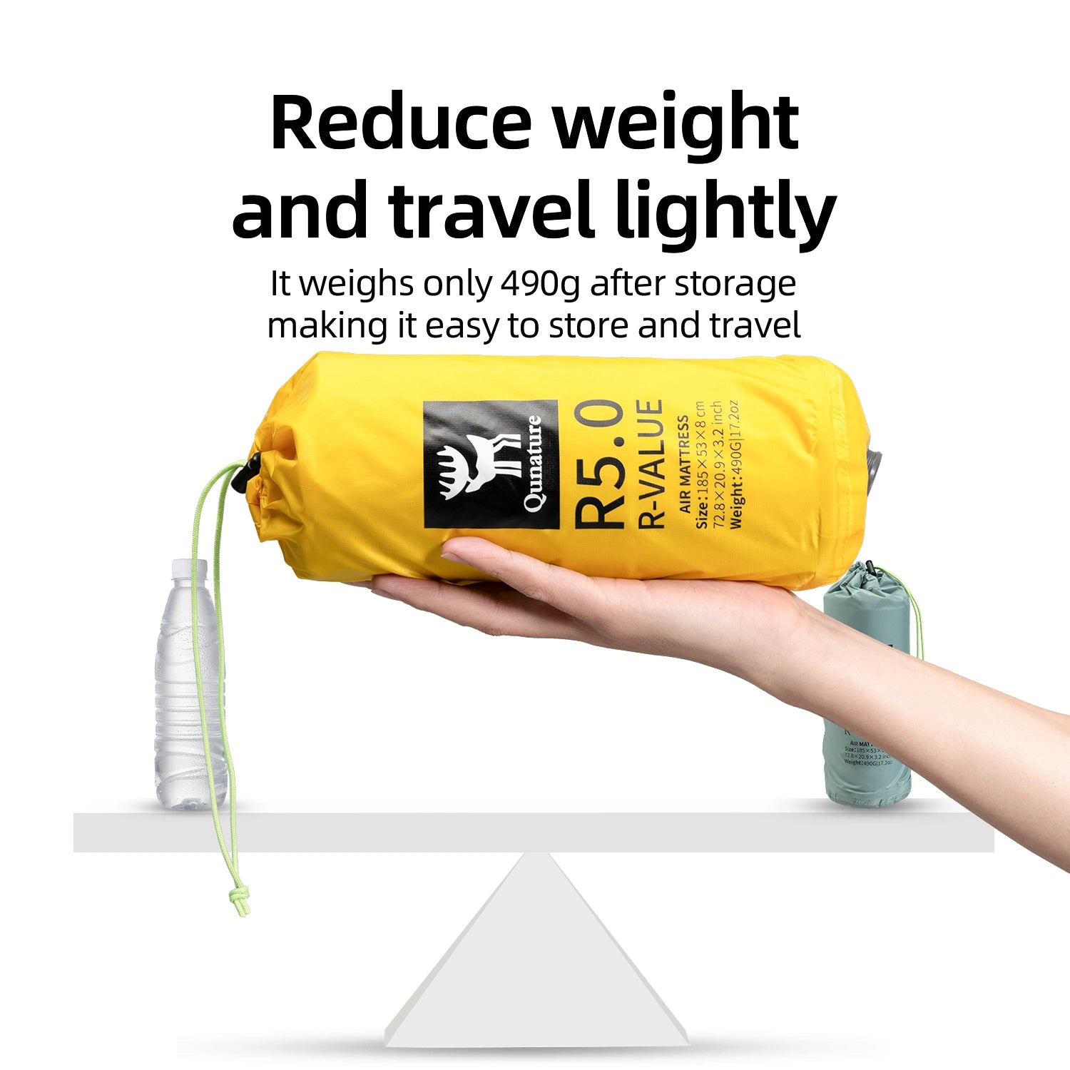 The Yellow compression bag is held in one hand with a balanced scale next to it, demonstrating its lightness.