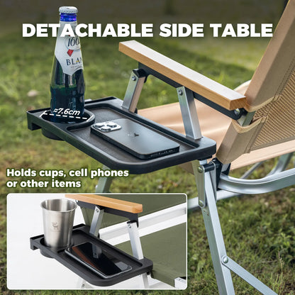 Detachable side table attached to a chair with a bottle and phone on it, grassy background