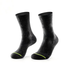 A pair of black ribbed crew socks with a thin neon yellow-green accent line near the toes, displayed against a solid white background.