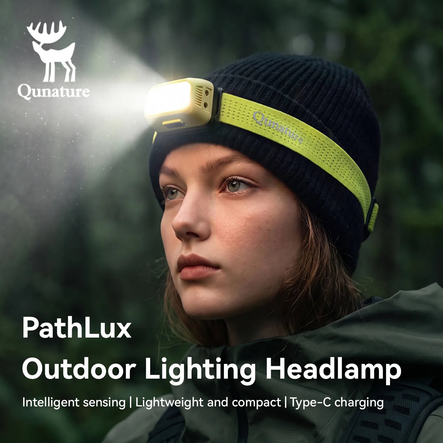 A woman outdoors wearing a Qunature PathLux headlamp attached to a black knit beanie. The headlamp is illuminated, with a bright light beam shining to the left.