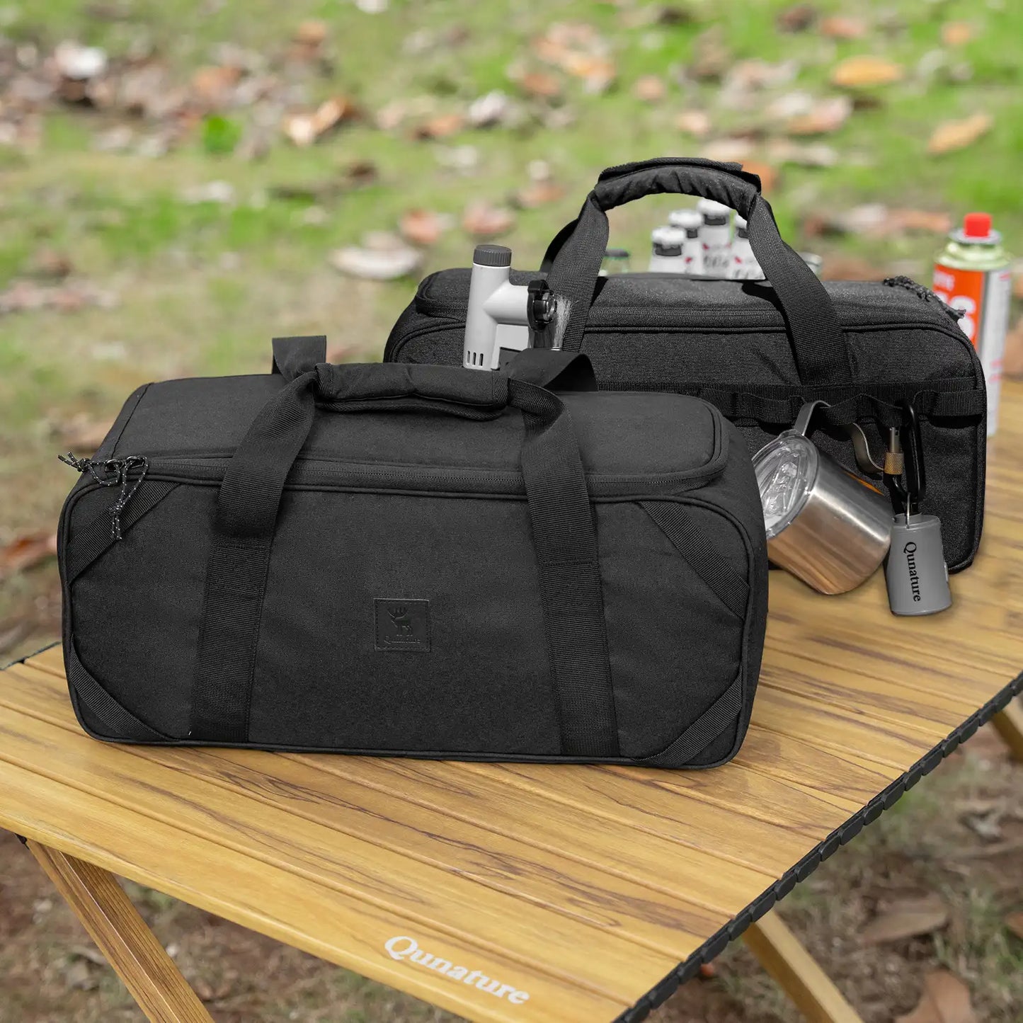 Black duffel bag on a wooden table with outdoor background