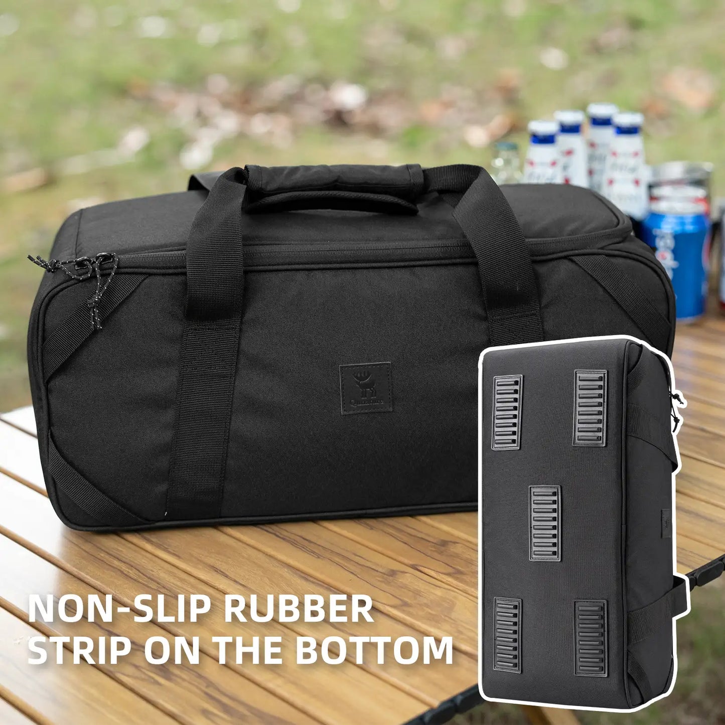 Black duffel bag with non-slip rubber strip on the bottom, placed on a wooden surface outdoors.