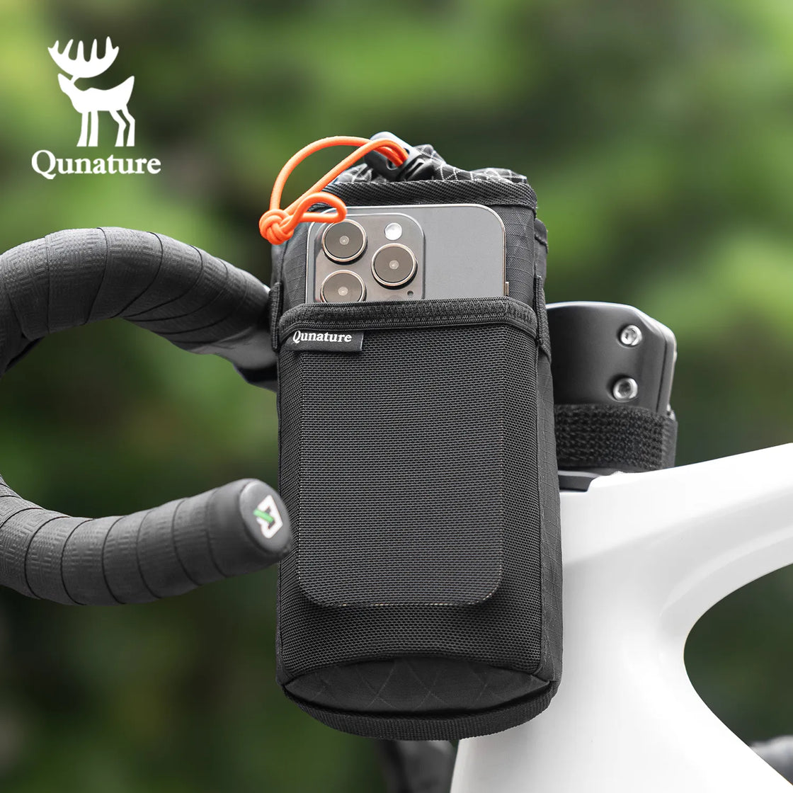 A mobile phone is placed in the side net pocket of a water bottle bag tied to a bicycle
