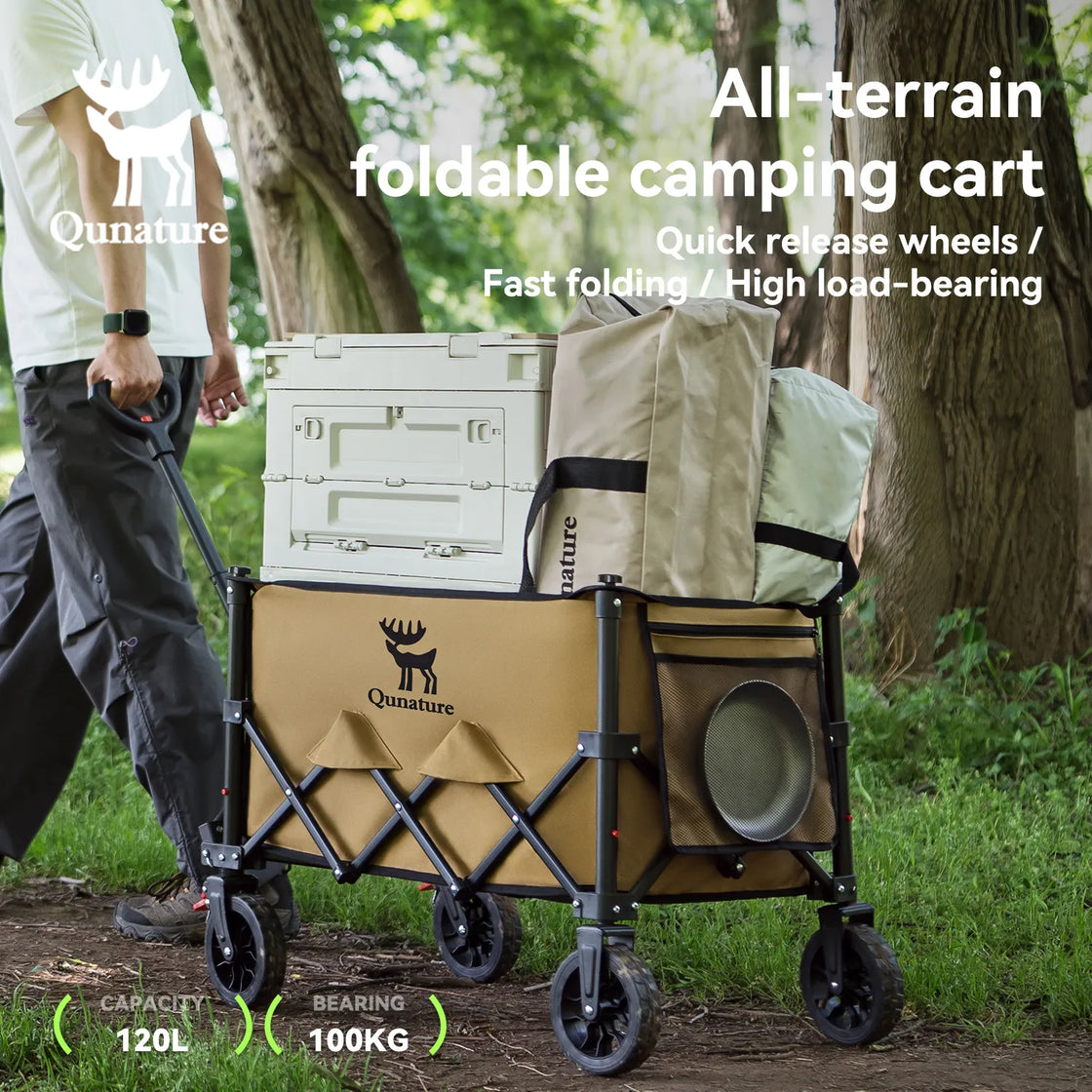 A man pulling a utility wagon full of camping supplies outdoors