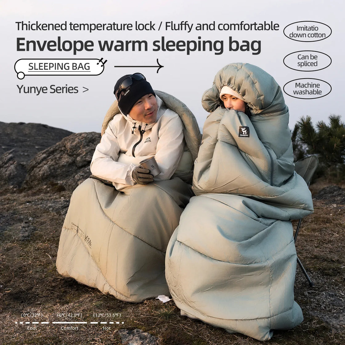 a boy and a girl wearing sleeping bags sit on chairs and talk outdoors on the mountain