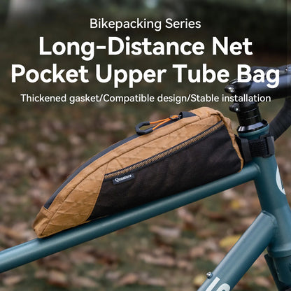 A khaki top tube bike bag with lots of storage pockets is mounted on a bicycle outdoors