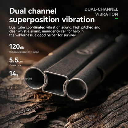 A close-up product shot of a dual-channel metal whistle made from two square-profile tubes joined together, resting on rough wood. White marketing text overlays describe the 'Dual channel superposition vibration' feature, including 120dB sound, 5.