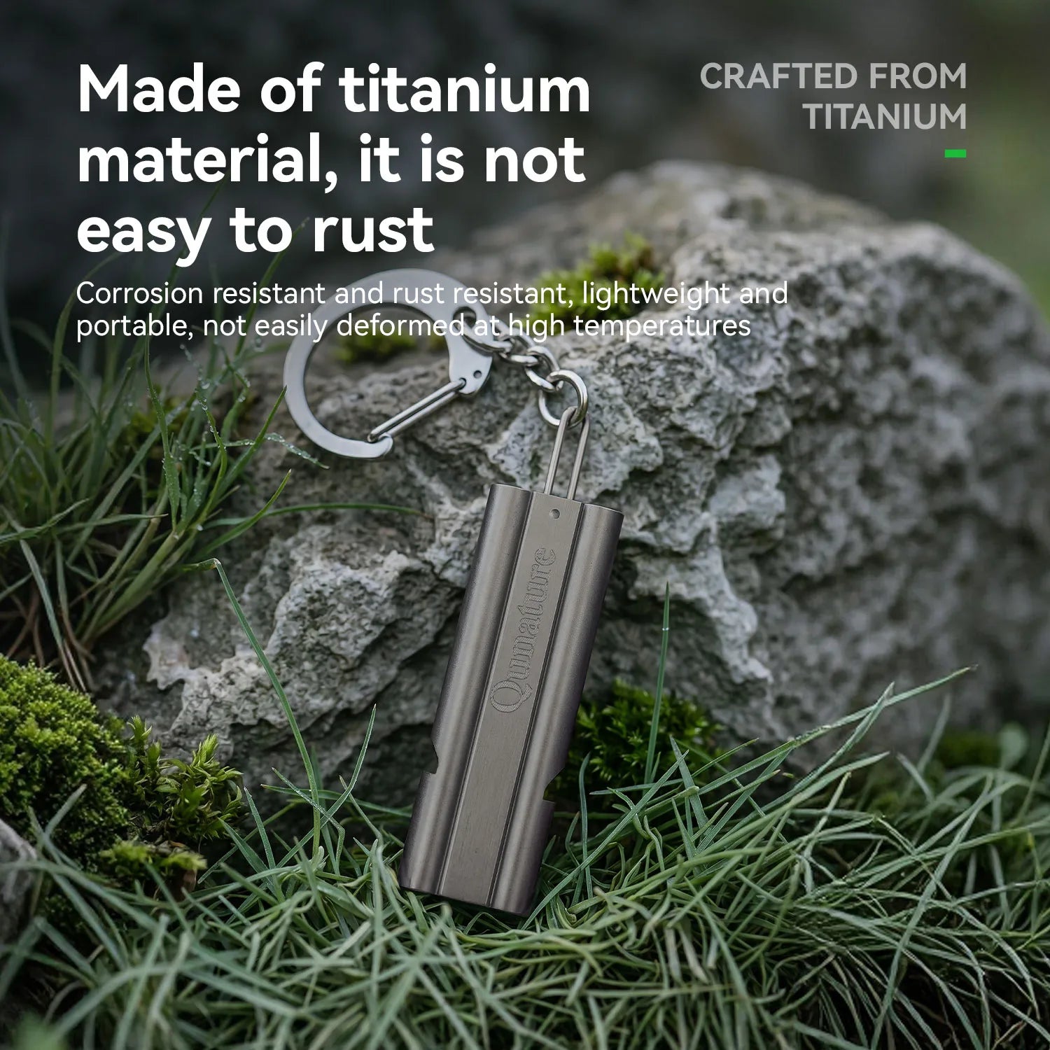 A titanium keychain battery holder with a metallic silver-gray finish, shown resting on green grass and a gray rock outdoors. White text overlays on the left describe its rust-resistant titanium material, and text on the top right reads 'CRAFTED FROM TITANIUM'.