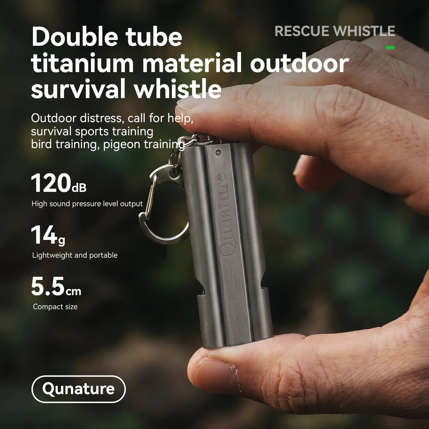A person's hand holding a compact metallic outdoor survival whistle with a key ring, shown with promotional text on a blurred green background. The text highlights features such as double tube titanium material, 120 dB sound, 14 g weight, and 5.