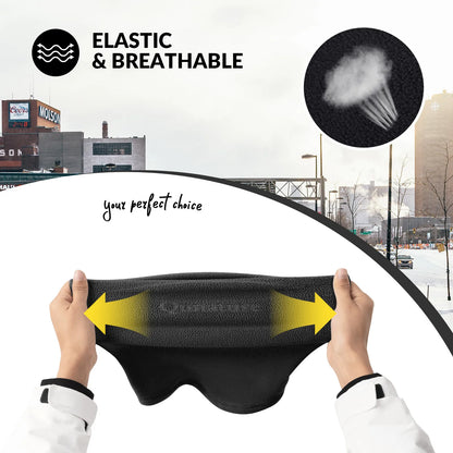 Person holding a black eye mask with yellow arrows, set against an urban background.