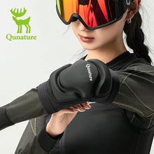 A girl wearing a pair of elbow pads and ski goggles