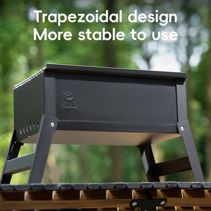 Black grill with trapezoidal design and brand logo, set against a blurred green outdoor background.