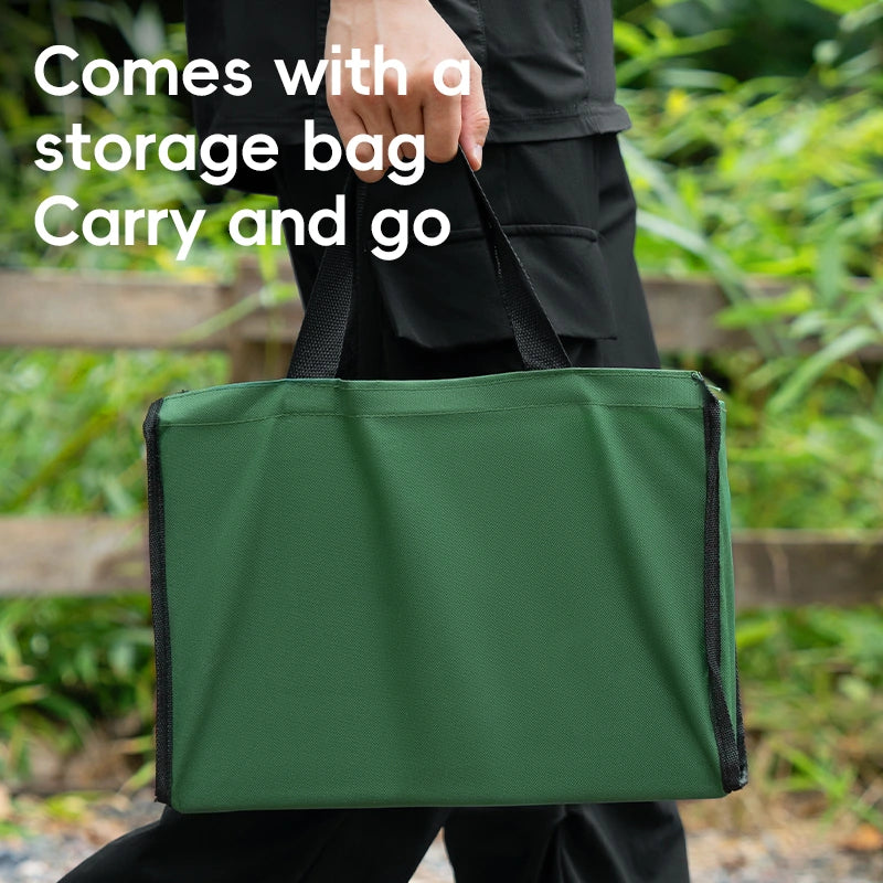 Person holding a green storage bag with text 'Comes with a storage bag Carry and go' in an outdoor setting.