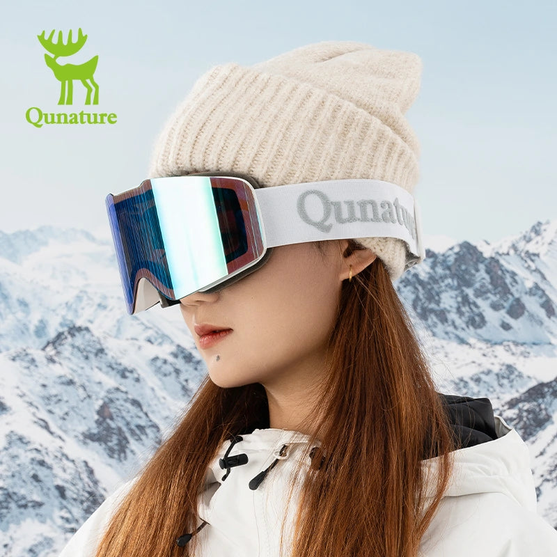 A girl wearing frameless bule silver anti-fog ski goggles and a snow helmet