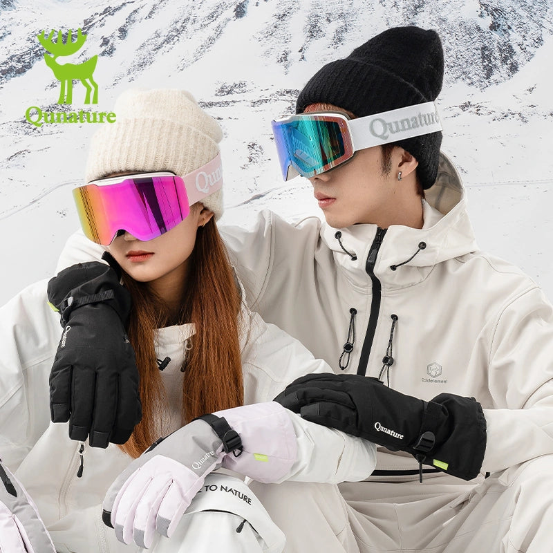 A girl wearing frameless red anti-fog ski goggles and a boy wearing frameless blue anti-fog ski goggles
