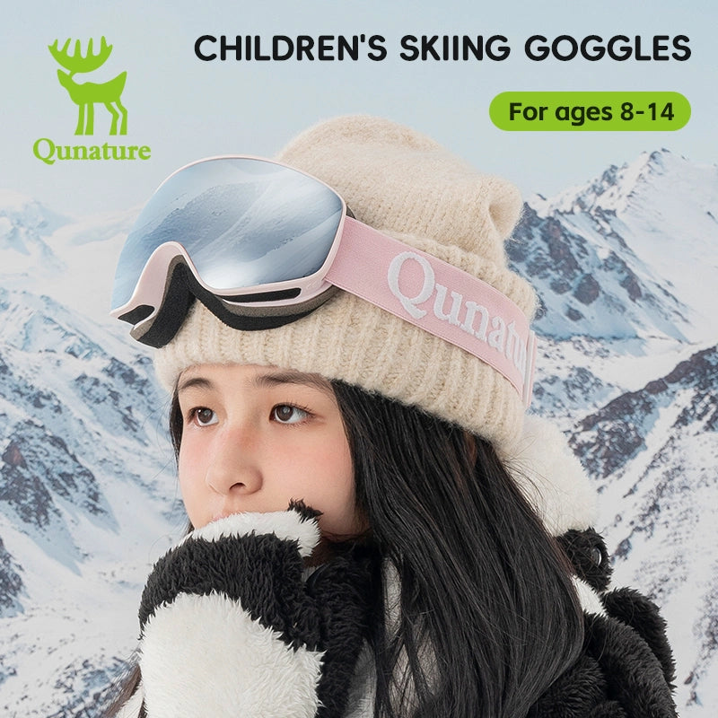 A girl wearing a pair of kids anti-fog ski goggles with UV protection, with pink straps and grey lenses