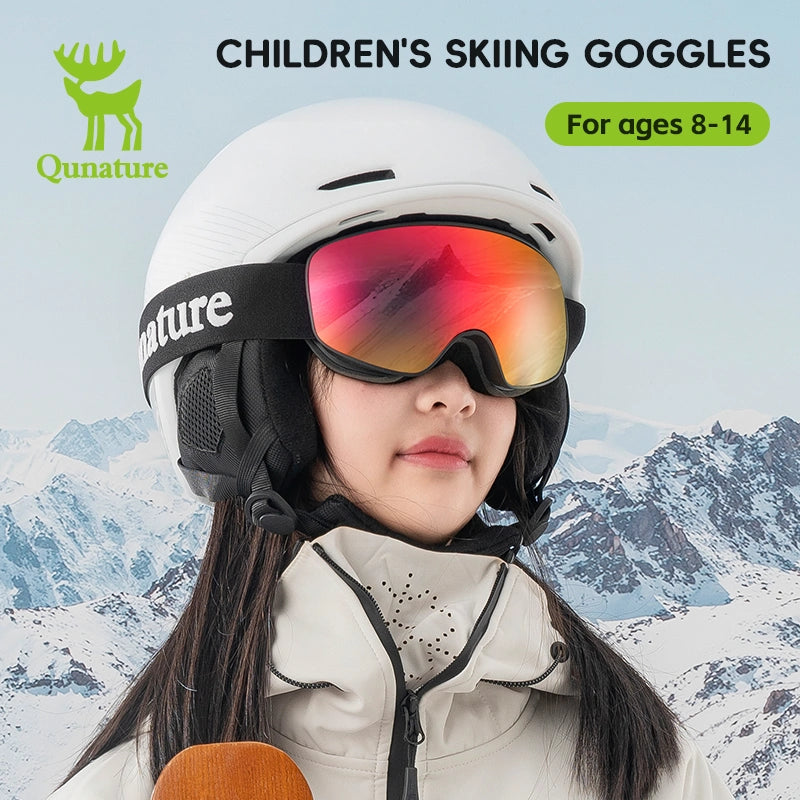 A girl wearing a pair of kids anti-fog ski goggles with UV protection, with black straps and red lenses
