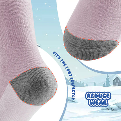 Close-up of socks with gray heel and toe reinforcements, set against a snowy landscape background.