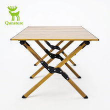 Foldable wooden table with black metal legs on a white background, featuring the Qunature brand logo.