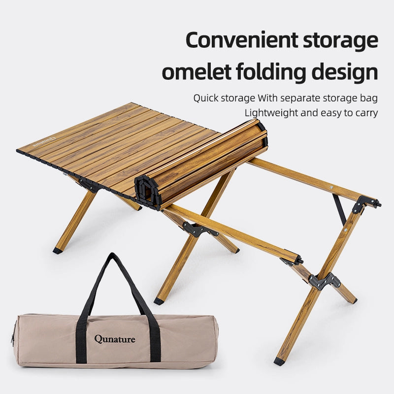 Foldable wooden table with a carrying bag on a white background, featuring the brand 'Qunature'.