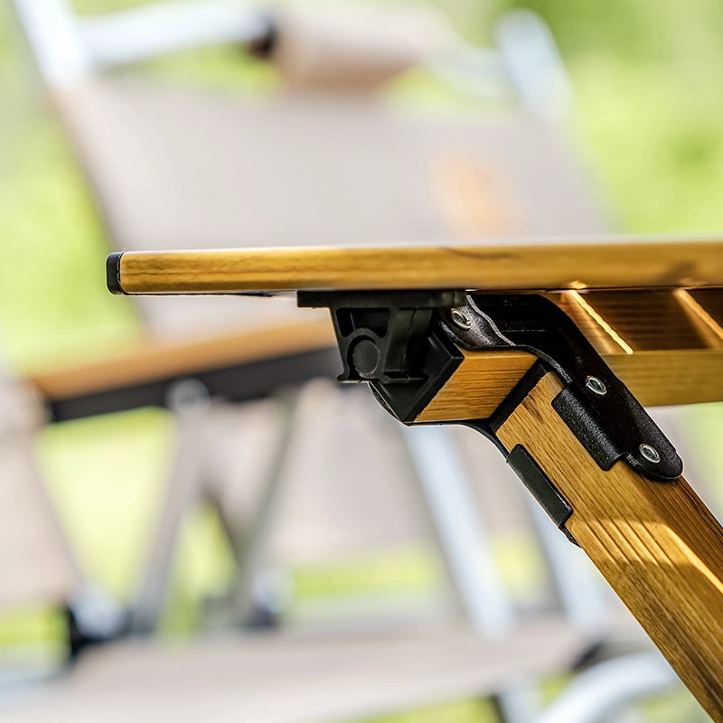 Wooden folding chair with a metal bracket in an outdoor setting