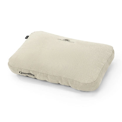 A Qunature travel neck pillow in a light beige textured fabric, shown at an angle on a clean white background.