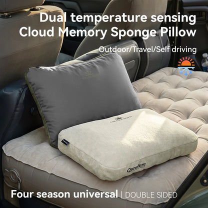 Two cloud memory memory foam pillows in gray and beige, shown resting on an inflatable car bed inside a vehicle. Text overlays describe the dual temperature sensing feature and outdoor/travel use.
