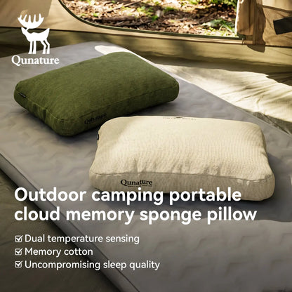 Two Qunature outdoor camping pillows displayed on a camping mat inside a tent. One pillow is olive green and the other is cream-colored, with text overlays highlighting features like dual temperature sensing and memory cotton.