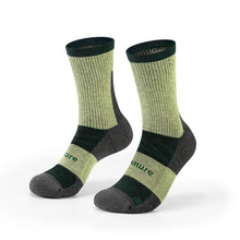 A pair of crew-length athletic socks in olive green and dark gray, featuring a ribbed knit upper, dark green cuffs, and the brand name 'nature' printed on the side.