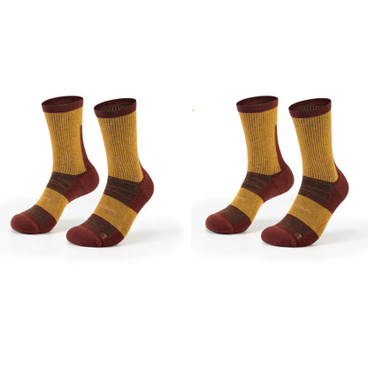 Four pairs of crew socks displayed side by side on a clean white background. The socks feature a color-blocked design with a mustard yellow ribbed leg, a dark brown band, and a deep burgundy toe, heel, and cuff.