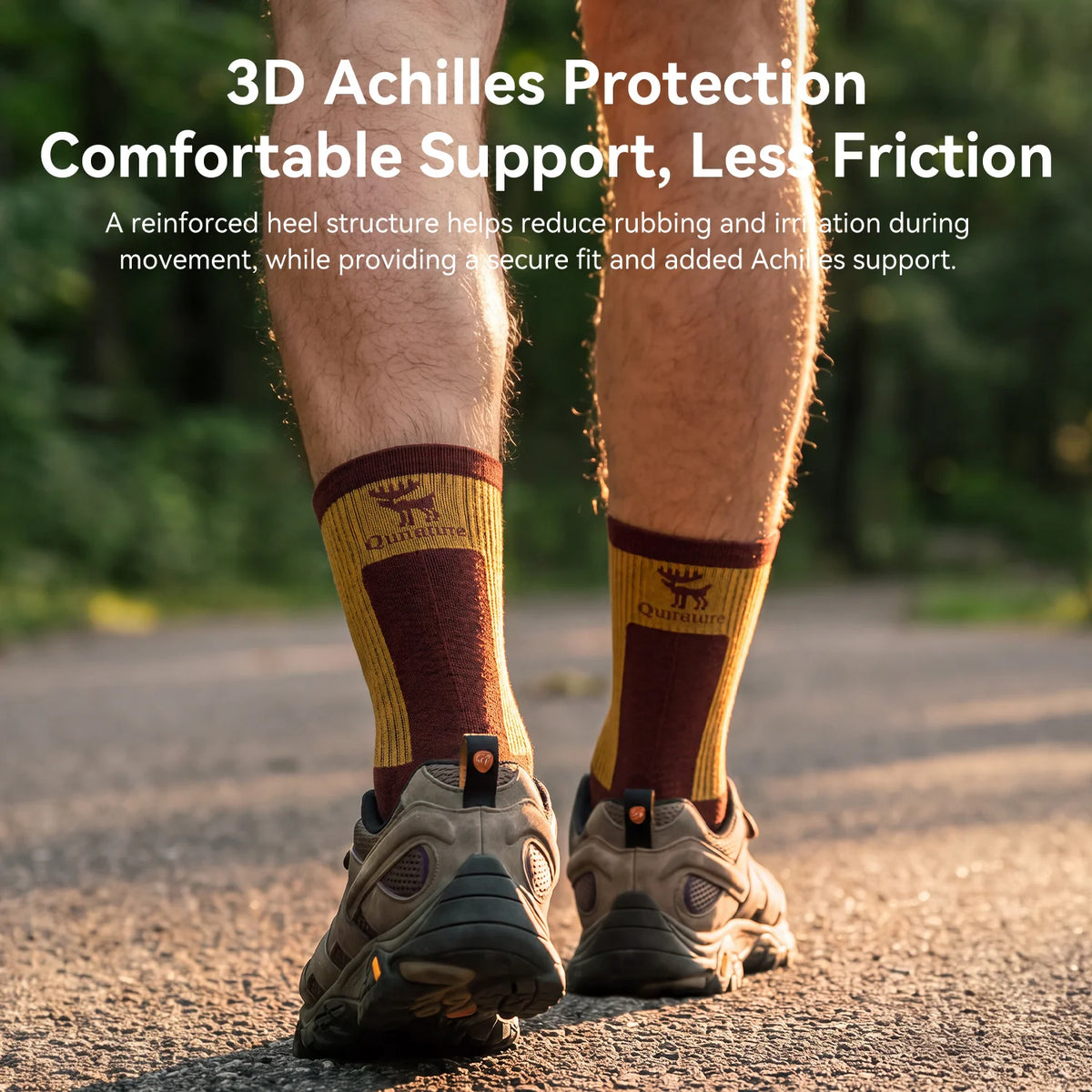 A person walking on a paved path wearing brown and mustard yellow athletic socks with a logo and hiking shoes. White text at the top reads '3D Achilles Protection Comfortable Support, Less Friction' with a descriptive product feature callout.