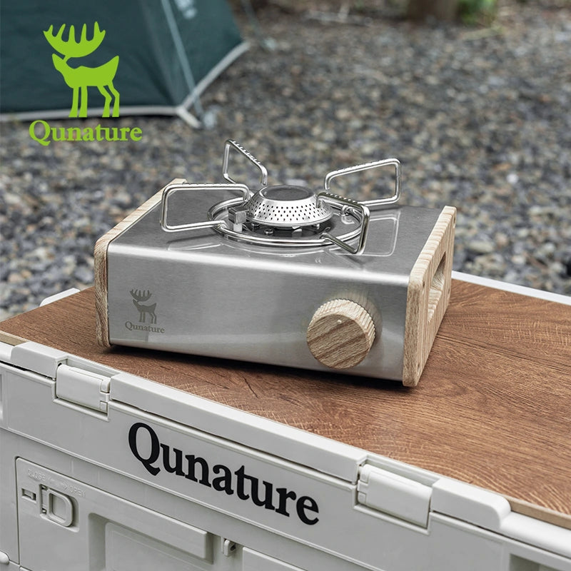 Camping stove on a wooden surface with Qunature branding