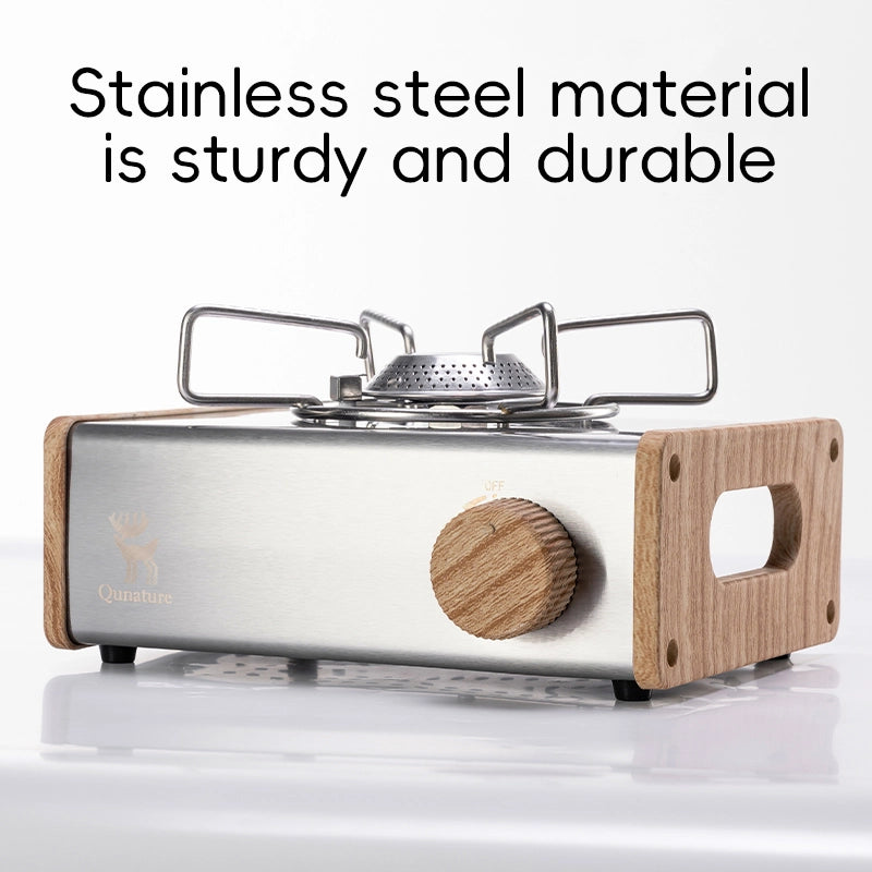 Stainless steel portable stove with wooden handle and base on a white background
