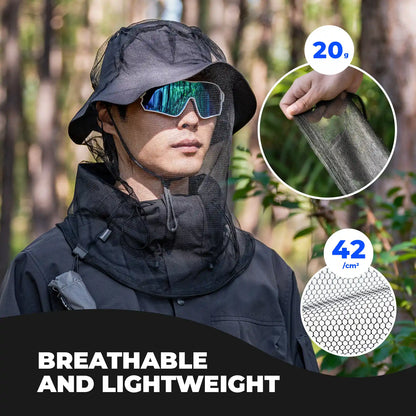 Person wearing a black insect repellent hood with a forest background