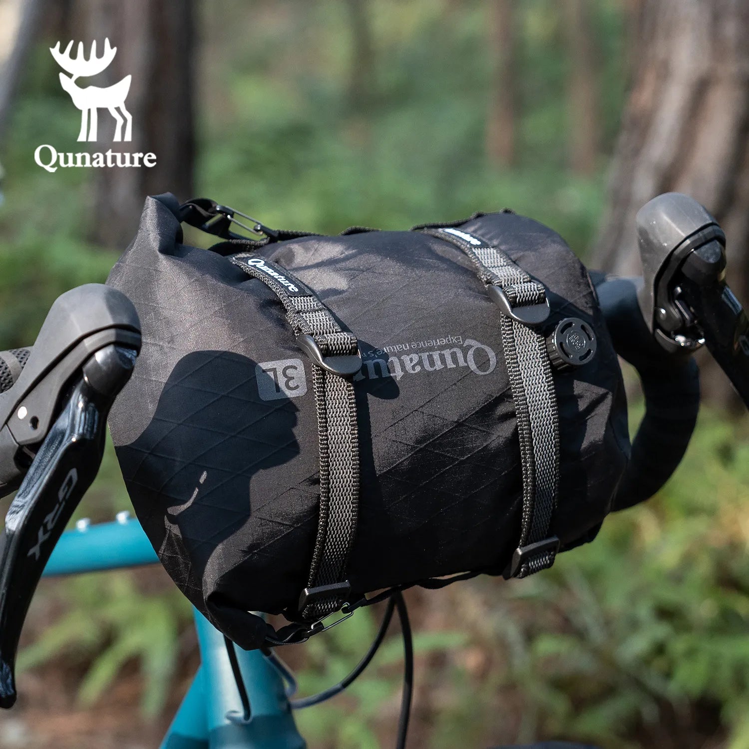 A black multi-purpose cargo binding belt is used to tie a black bag to the front of the bicycle.