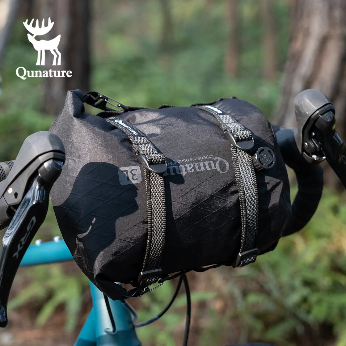 A black multi-purpose cargo binding belt is used to tie a black bag to the front of the bicycle.