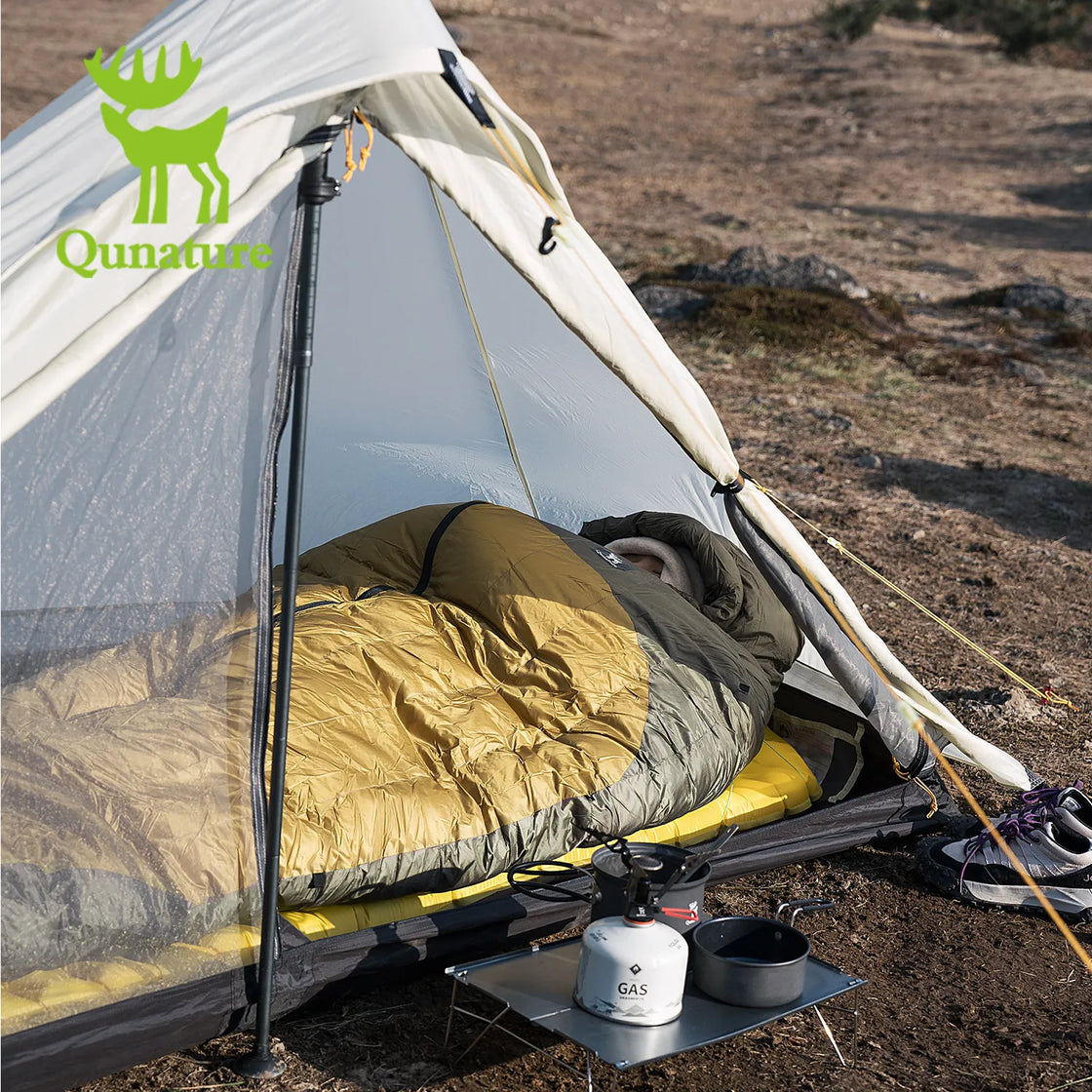 a man sleeping in a mummy sleeping bag in a tent outdoors