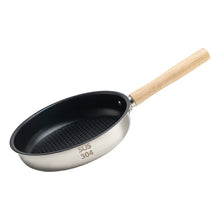 A silver stainless steel frying pan with a black non-stick honeycomb surface and a detachable beech handle.