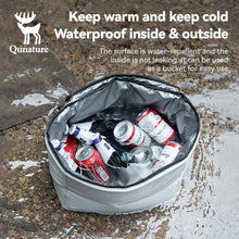 Insulated cooler bag with drinks on a wet pavement, featuring Qunature branding.